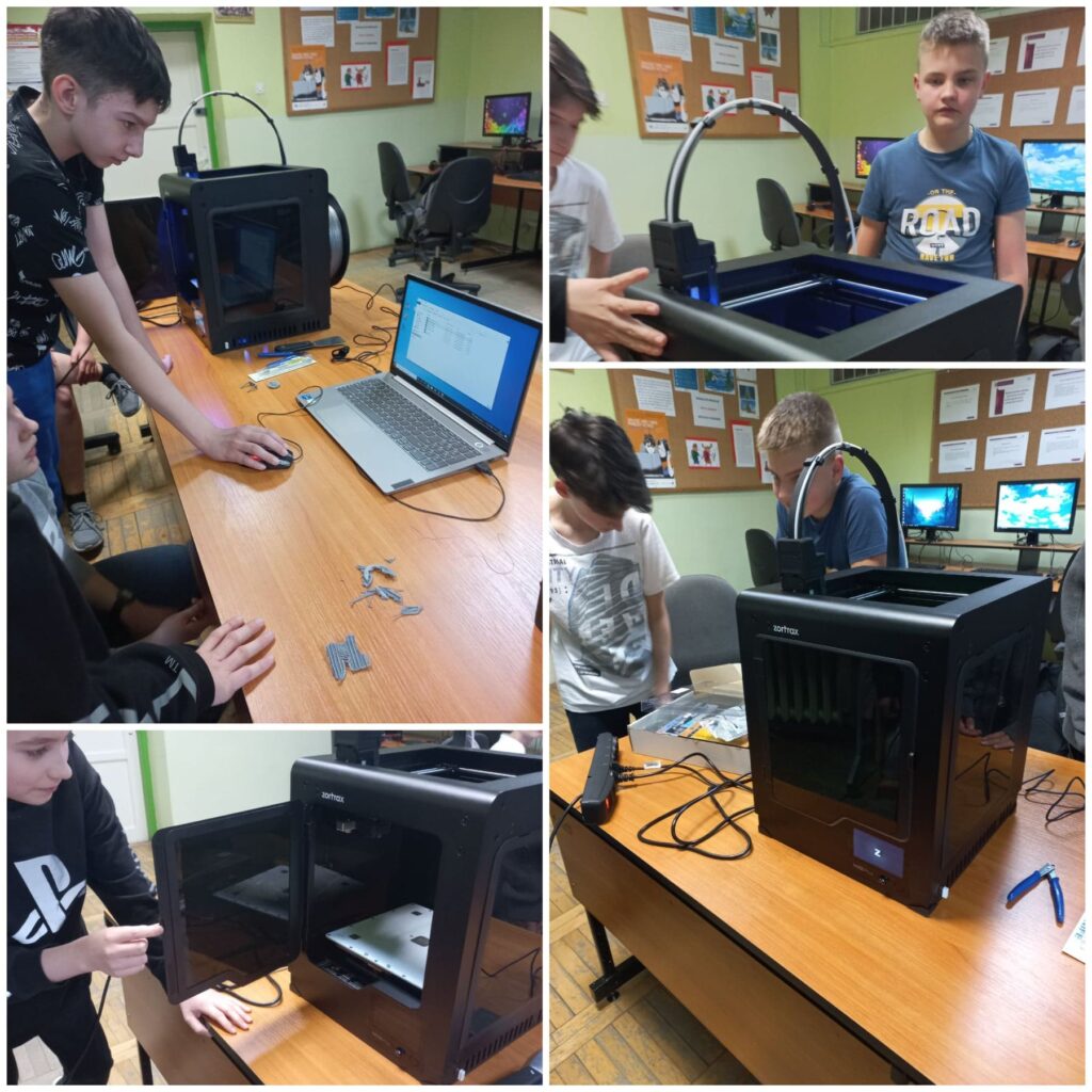 Uczniowie pracują na drukarce 3D